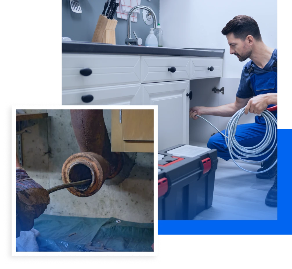 Plumber using a drain snake to clear a clogged pipe under a kitchen sink, showcasing plumbing repair services by R&A Industries in a residential setting.