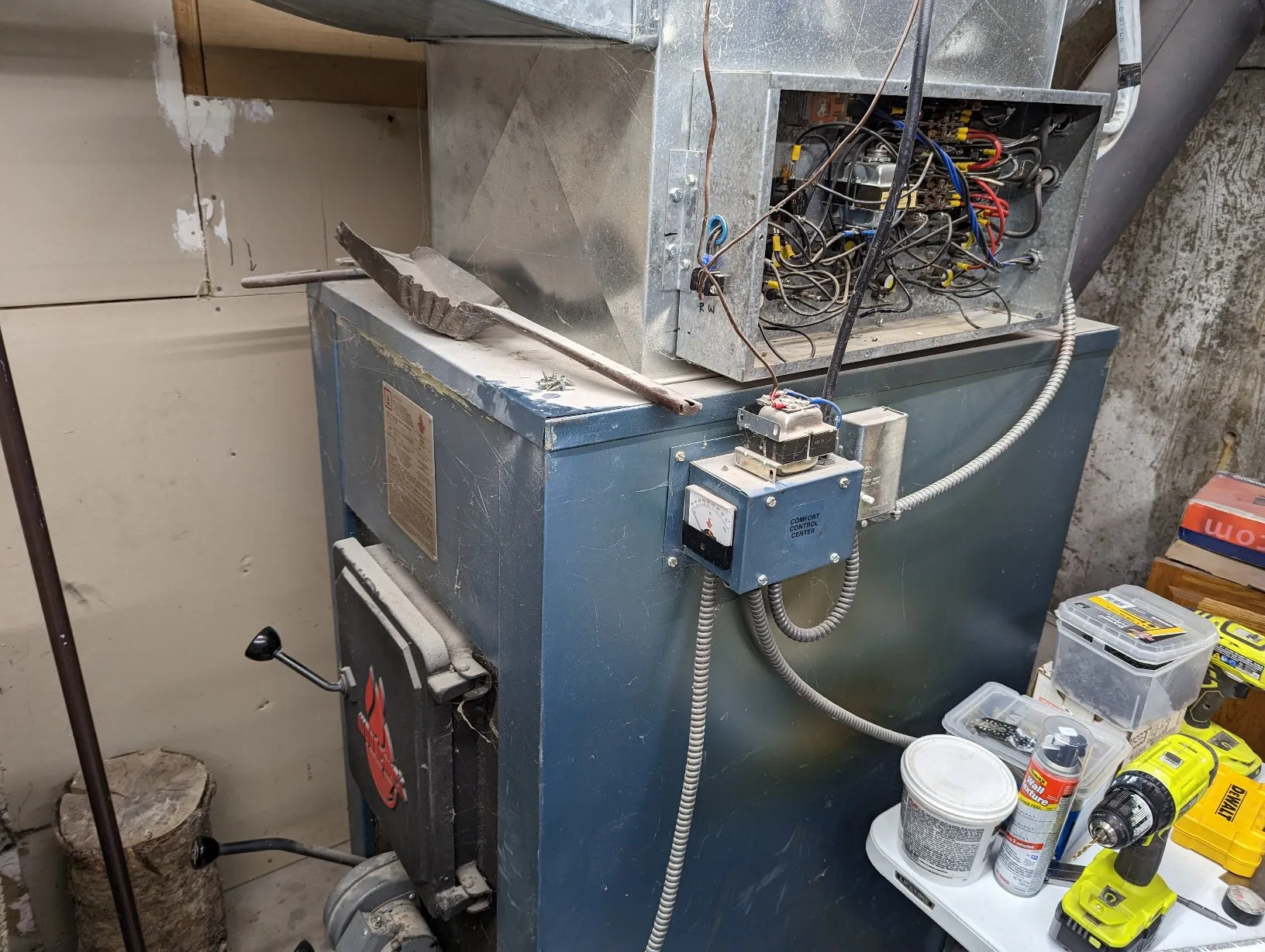 Old furnace with open electrical box showing wires. Home heating system needing repair or replacement. Oviedo, FL furnace issues.