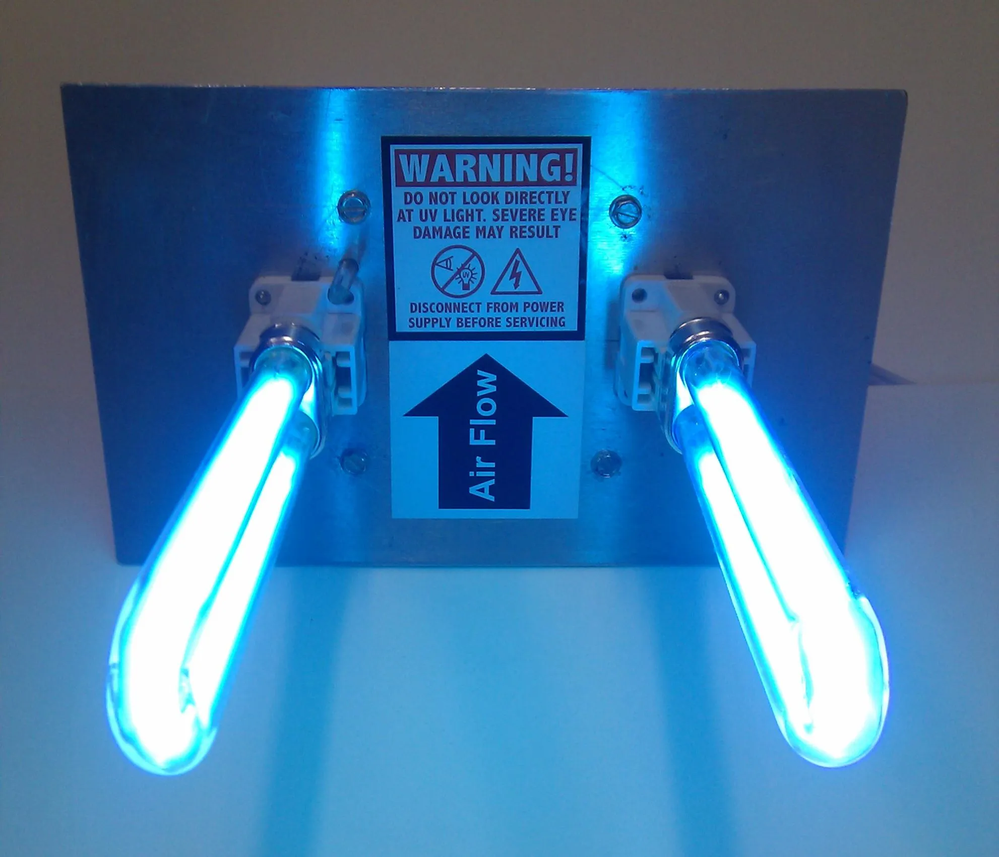 UV light air cleaning system. Warning: Do not look directly at UV light, severe eye damage may result. Air flow direction shown.