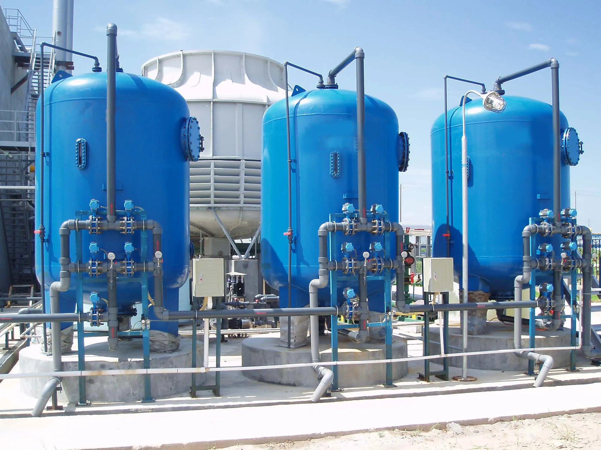 Industrial air cleaning system with blue tanks and pipework. Air purification equipment in Oviedo, FL.