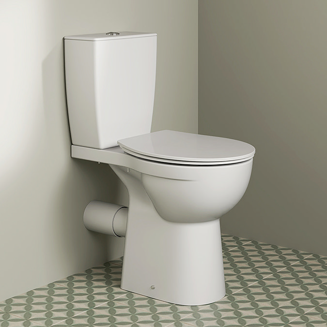 Modern white toilet installed in a bathroom with patterned floor tiles, representing reliable plumbing solutions for Oviedo homeowners.