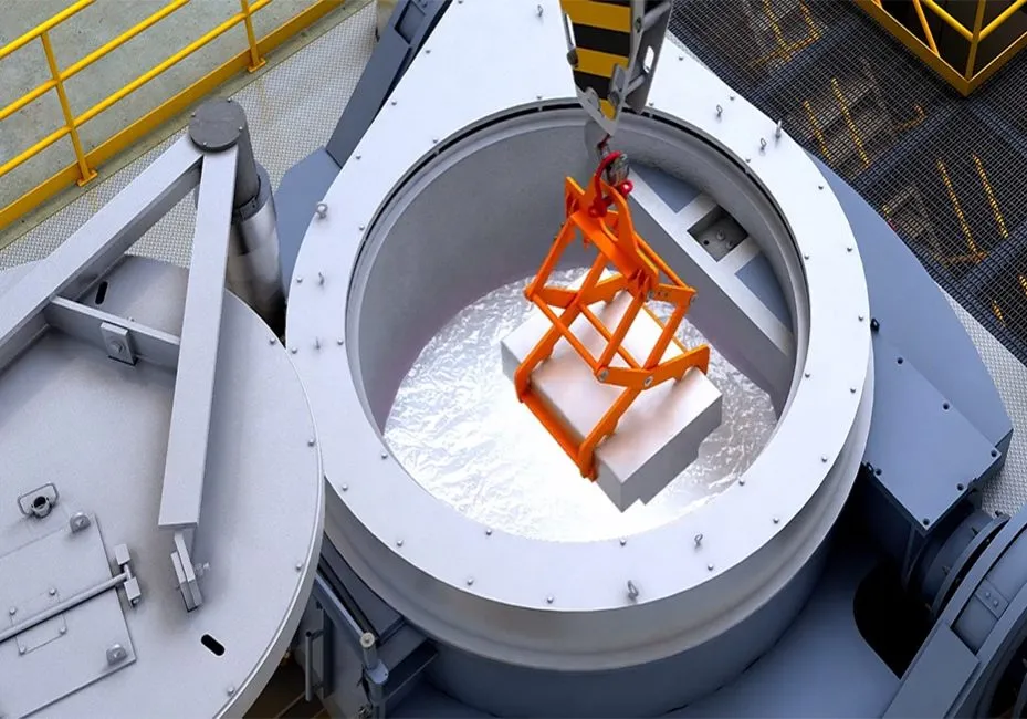 Industrial furnace with a block being lowered inside by a crane. Metalworking furnace in Oviedo, FL for industrial applications and heat treatment.