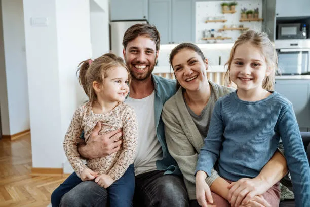 Happy family portrait indoors. Air Conditioning Maintenance ensures a comfortable home for families in Oviedo, FL.