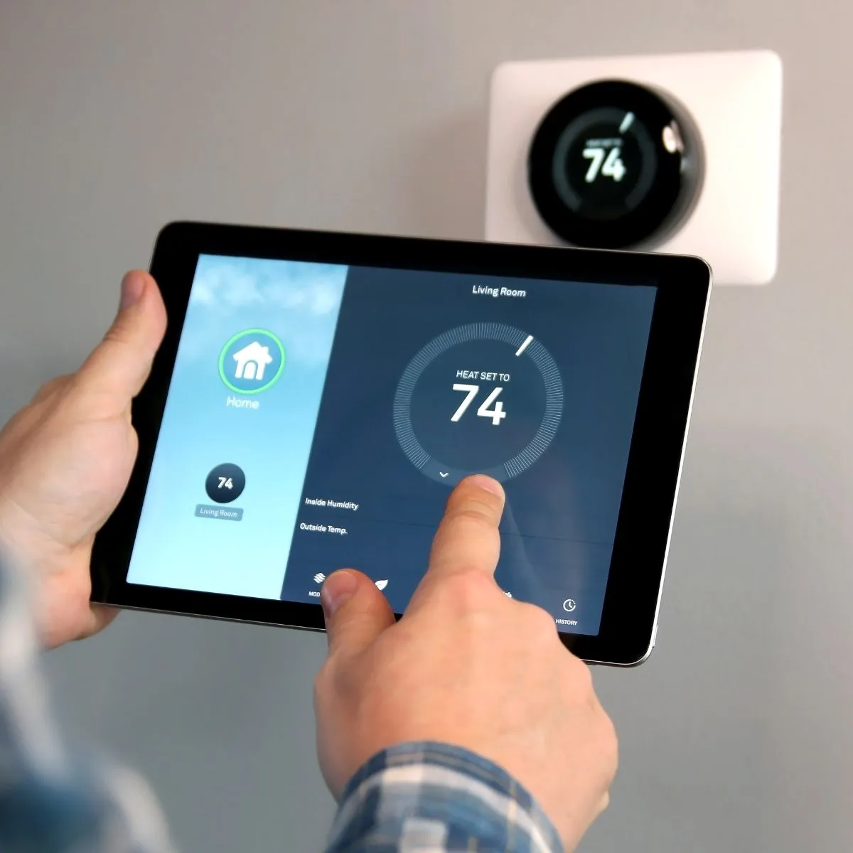 Smart thermostat control via tablet. Setting temperature for home comfort, Oviedo, FL. HVAC system control.