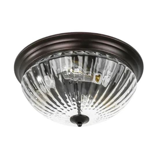 Indoor lighting installation: Close-up of a flush mount ceiling light fixture with a clear glass shade and dark bronze trim, Oviedo, FL.