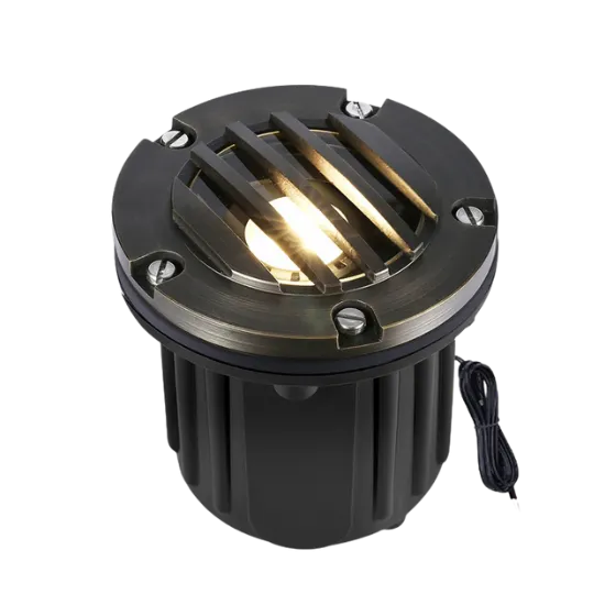 Recessed well light fixture for outdoor lighting installation, Oviedo, FL. Landscape lighting with a bronze finish and protective grate.